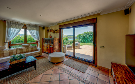 Living area with doors to terrace and sea views
